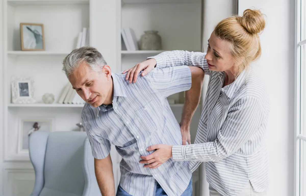 Chiropractor Examining Patient Back Pain