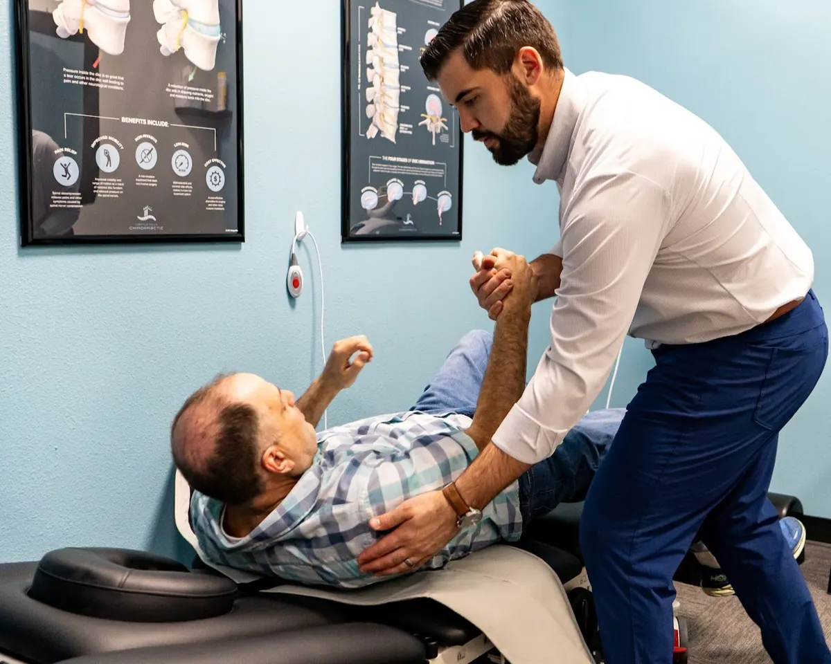 Chiropractor Performing Spinal Adjustment on Patient