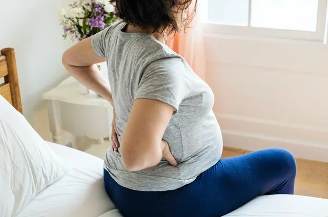 Pregnant Woman Experiencing Back Pain Relief