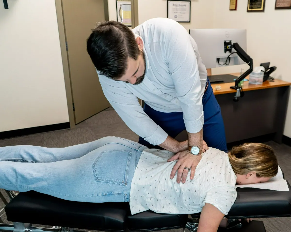 Chiropractor Performing Spinal Adjustment on Patient