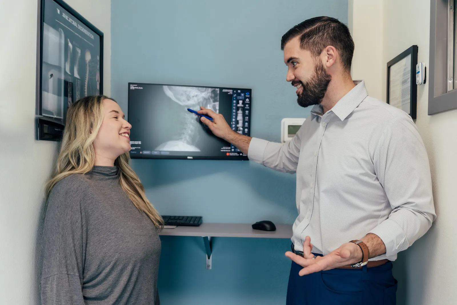Dr Brent Johnson explain to her patient the X-ray of the spine