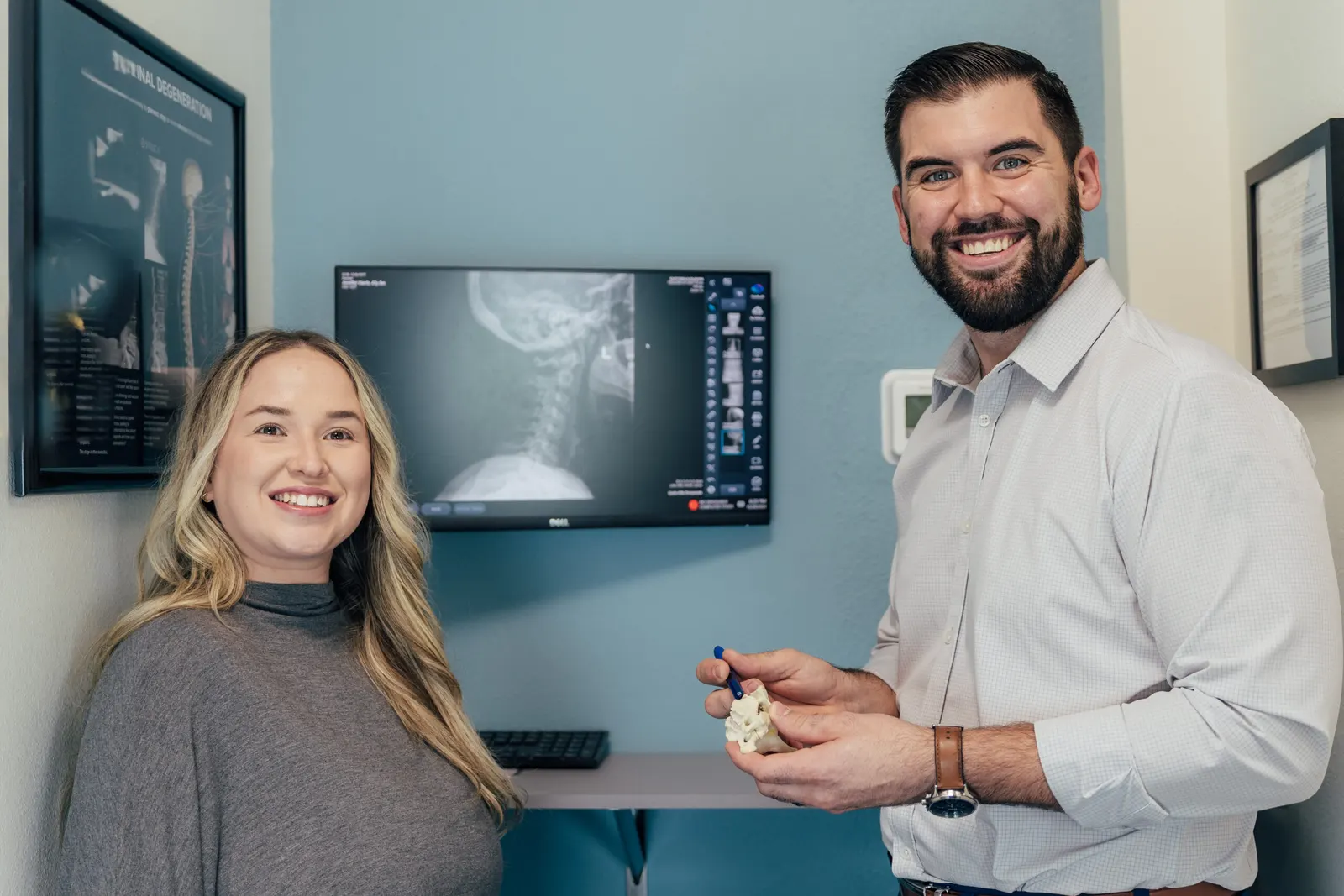 Dr Brent Johnsons showing the patient the spine X-ray result