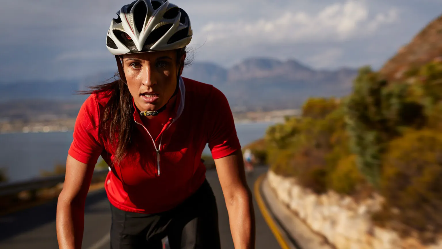 A woman driving a bike in to the road