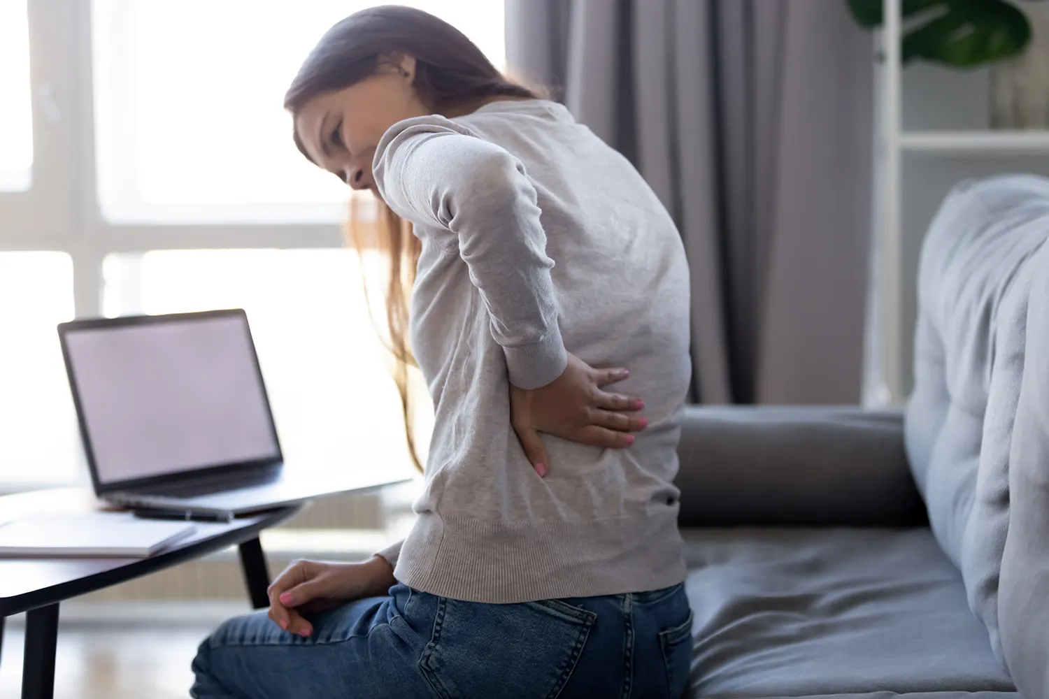 a woman suffering from slipped disc after her work