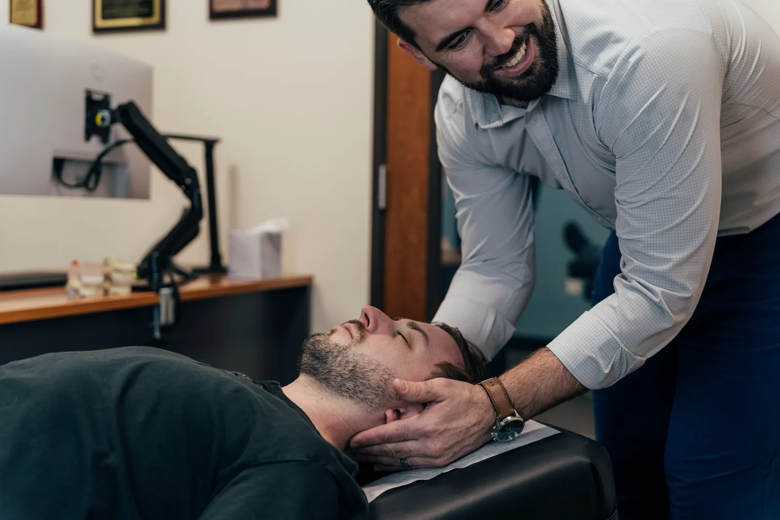 Dr brent Johnson giving his patient a headache treatment