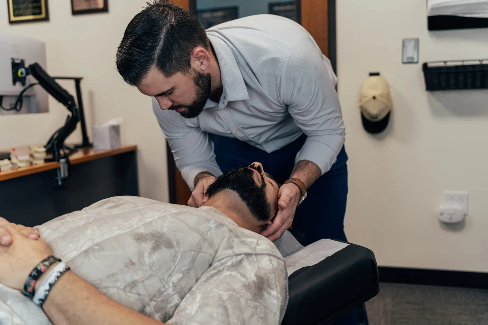 Dr Brent Johnson giving his patient migraine treatment
