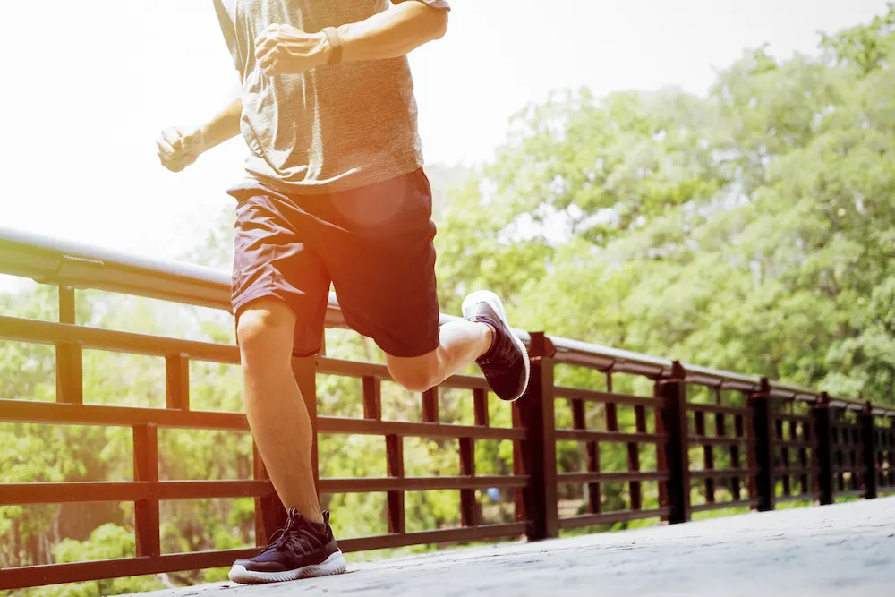 a man jogging around he park